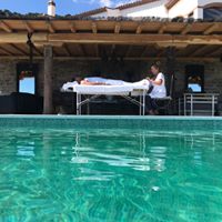 Client enjoying a Swedish Massage and Foot reflexology by their Pool